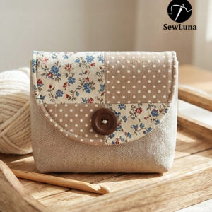 Beige linen button flap pouch with floral and polka dot patchwork design featuring a large wooden button closure. Completed sample of the Laurel PDF sewing pattern for a small clutch or cosmetic bag.