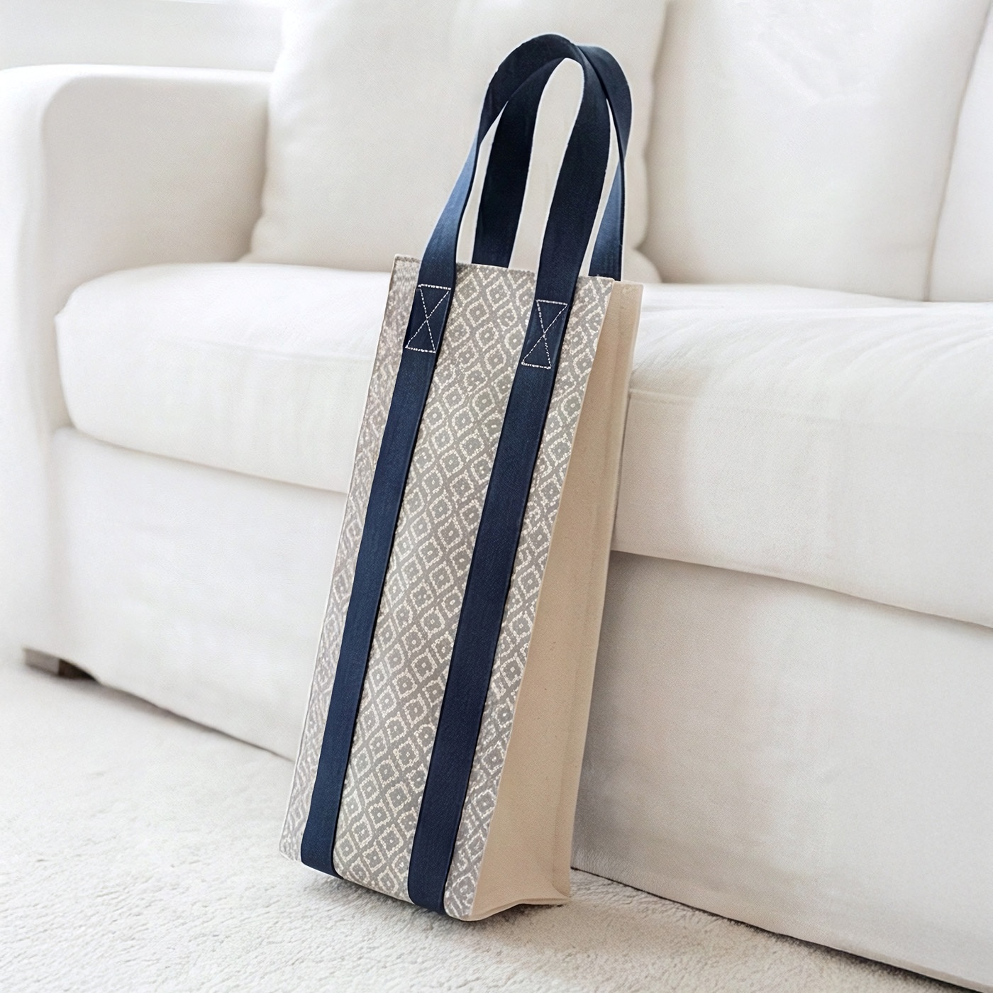 The elegant Celine Wine Carrier leaning against a white sofa