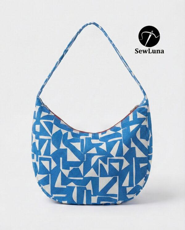 Model wearing the Azure Hobo Bag, a blue and white geometric print slouchy shoulder bag with a wide integrated strap. The bag has a curved crescent silhouette and is shown as a finished example of this digital sewing pattern.