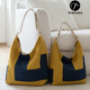 Two finished Aris hobo bags sitting on a white rug against a sofa. The bags feature a modern geometric color-block design in mustard yellow and navy blue with canvas straps. The image displays the Original and Large sizes of this digital sewing pattern.