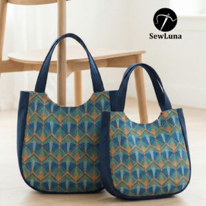 Two handmade curved tote bags in large and small sizes featuring a blue and teal geometric Art Deco print with navy blue trim and handles, displayed on a light wood floor next to a minimalist wooden chair.