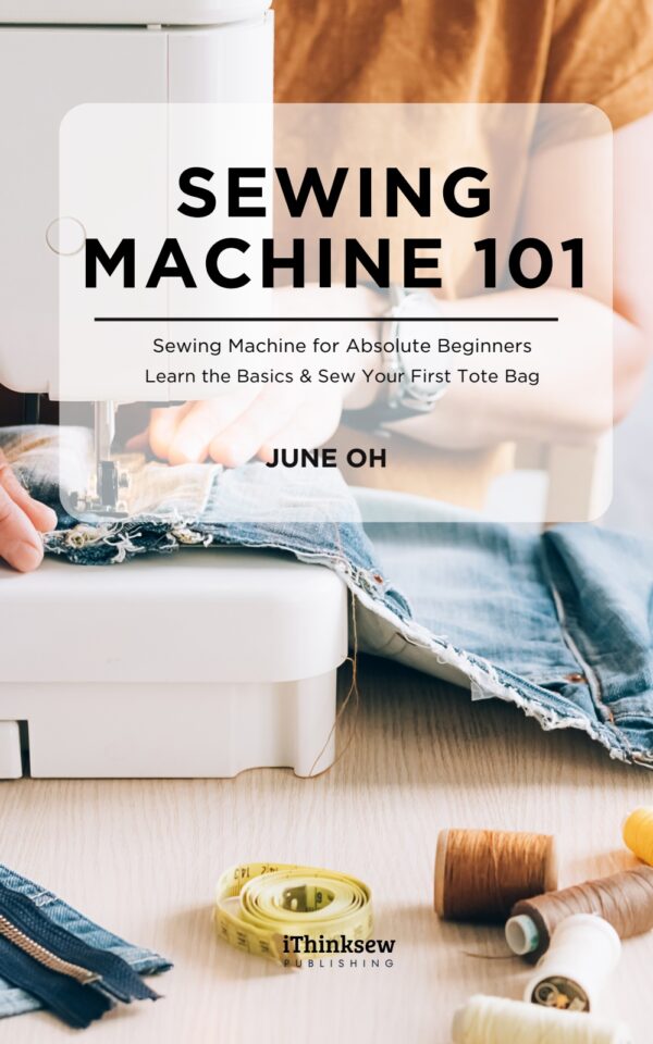 Digital e-book cover for Sewing Machine 101. A person is sewing denim fabric on a white sewing machine. A yellow measuring tape, colorful thread spools, and a zipper sit on a bright wooden table. An educational guide for sewing beginners